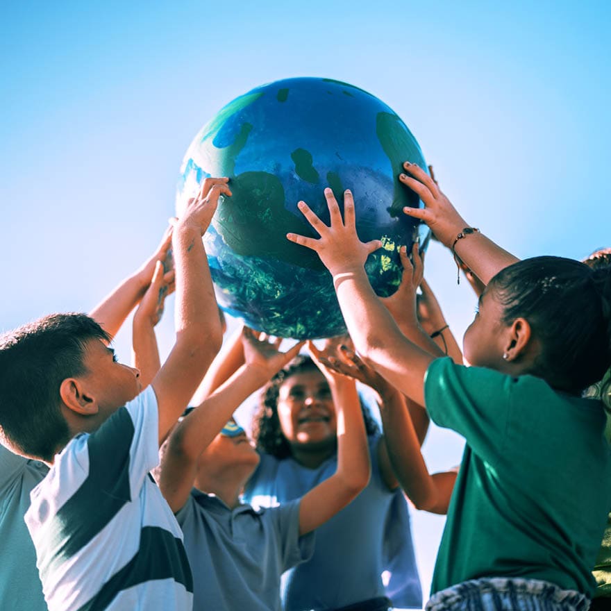 Children holding a planet outdoors
