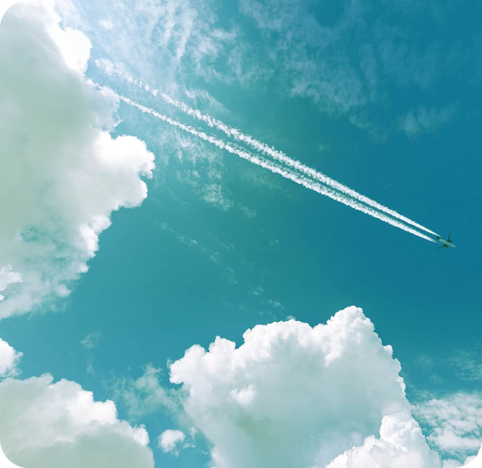 Airliner with contrails flying in a clear blue sky with beautiful cumulus clouds or cumulonimbus. Photography, Full frame.