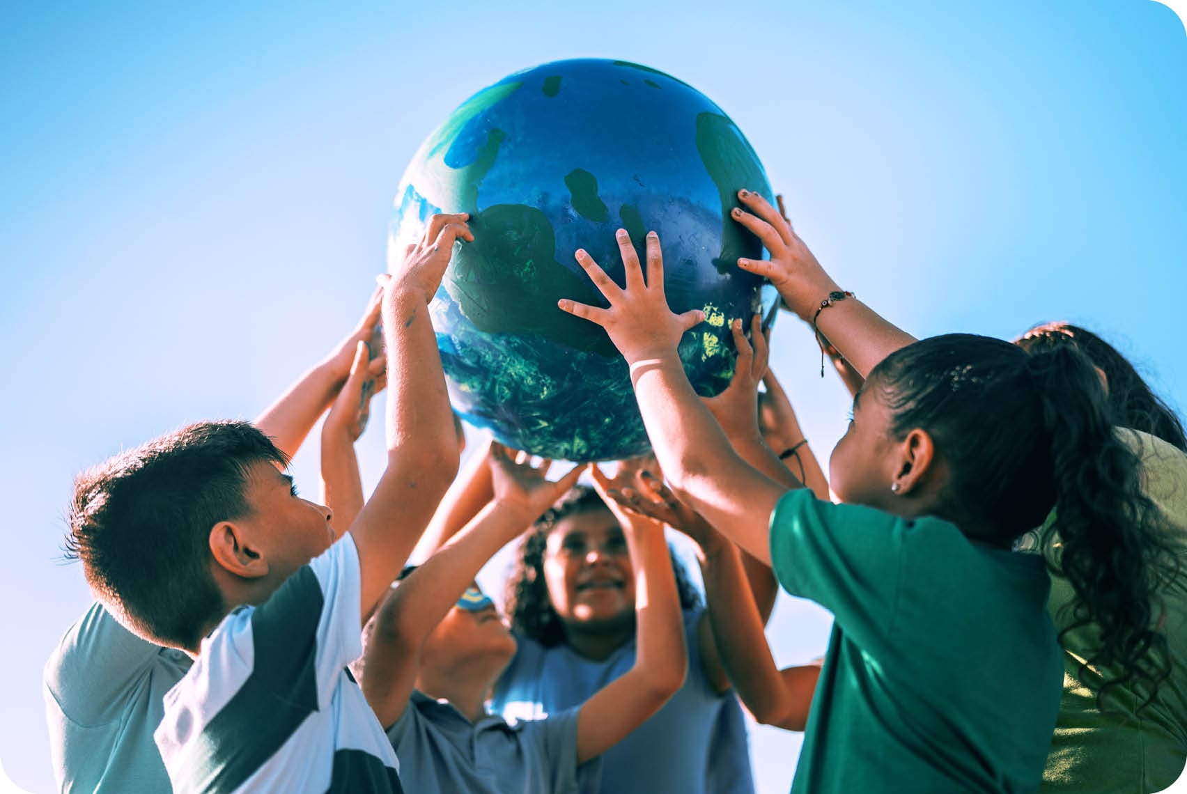 Children holding a planet outdoors