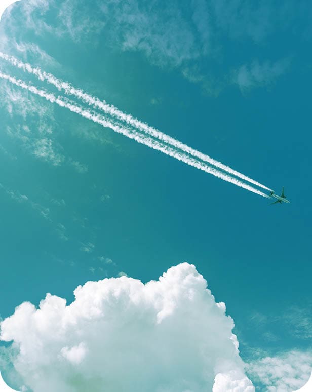 Airliner with contrails flying in a clear blue sky with beautiful cumulus clouds or cumulonimbus. Photography, Full frame.