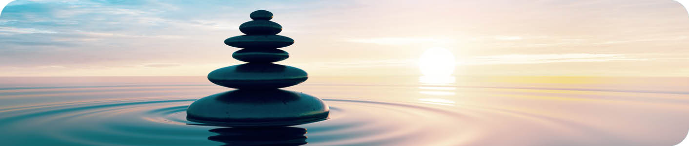 Stack of Stones in calm water with evening clouds