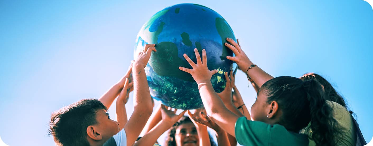 Children holding a planet outdoors
