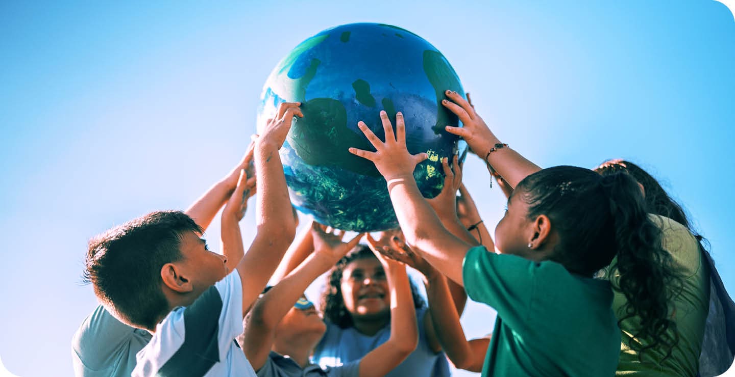 Children holding a planet outdoors