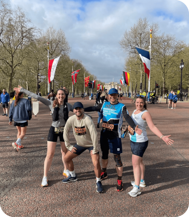 Four people are posing for a picture on a street. AI generated content