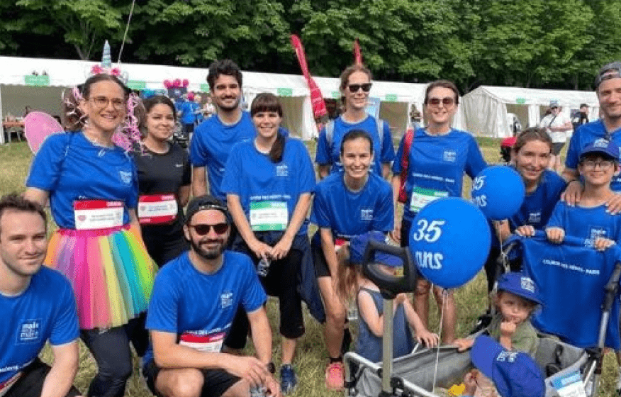 A group of people wearing blue shirts and holding signs pose for a picture. AI generated content
