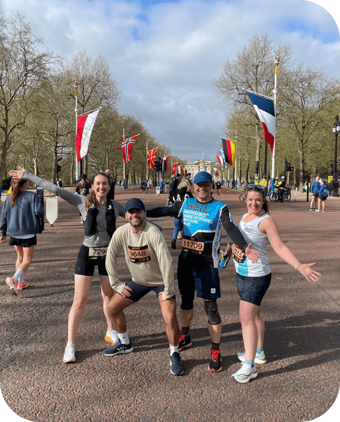 Four people are posing for a picture on a street. AI generated content