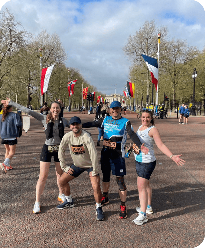 Four people are posing for a picture on a street. AI generated content