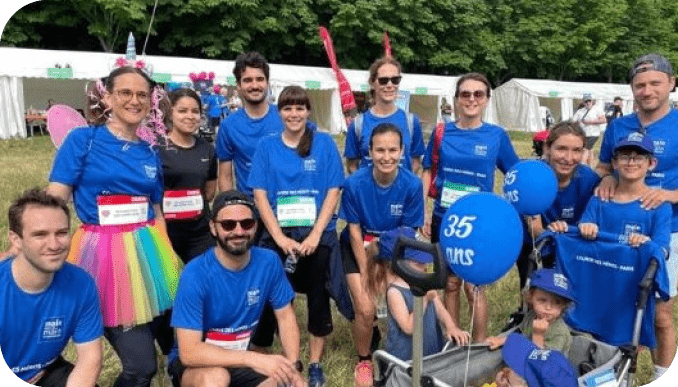 A group of people wearing blue shirts and holding signs pose for a picture. AI generated content